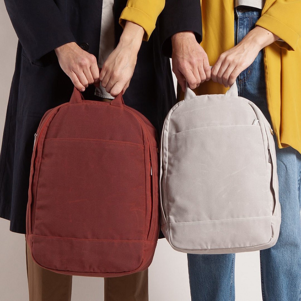 Two people holding Day Owl's sleek, eco-friendly backpacks curated by Swagger.
