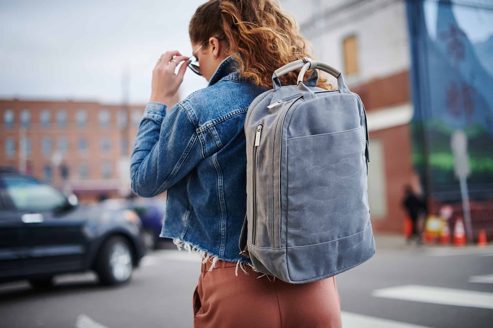 Woman wearing Day Owl's sustainable backpack, designed by Swagger.