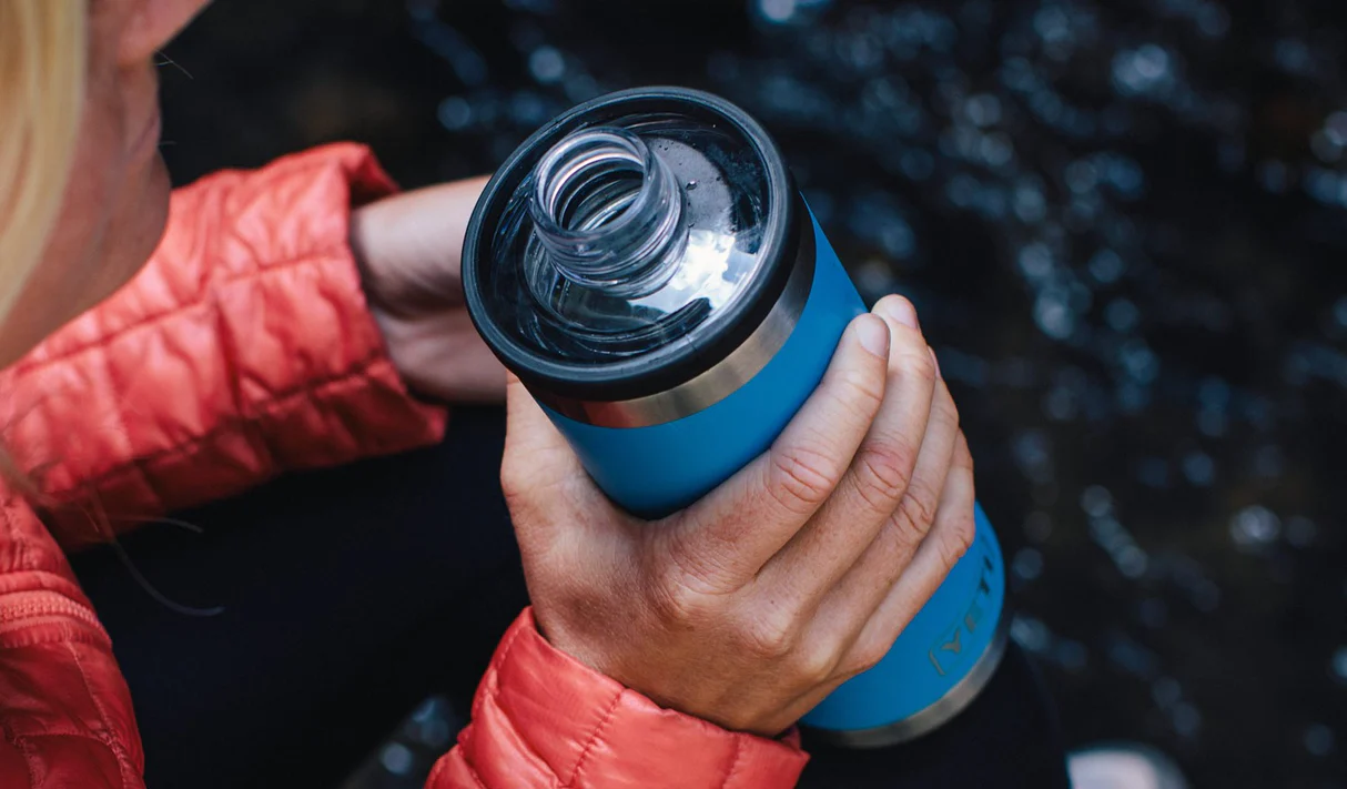 Person enjoying a hike with a customized YETI Rambler Bottle with Chug Cap Lid by Swagger.