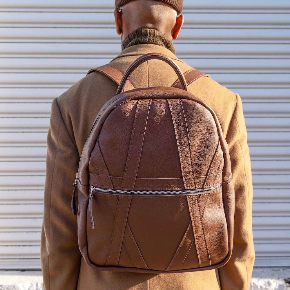 Product image of man wearing Ian James Leather Kingsley Backpack in brown.