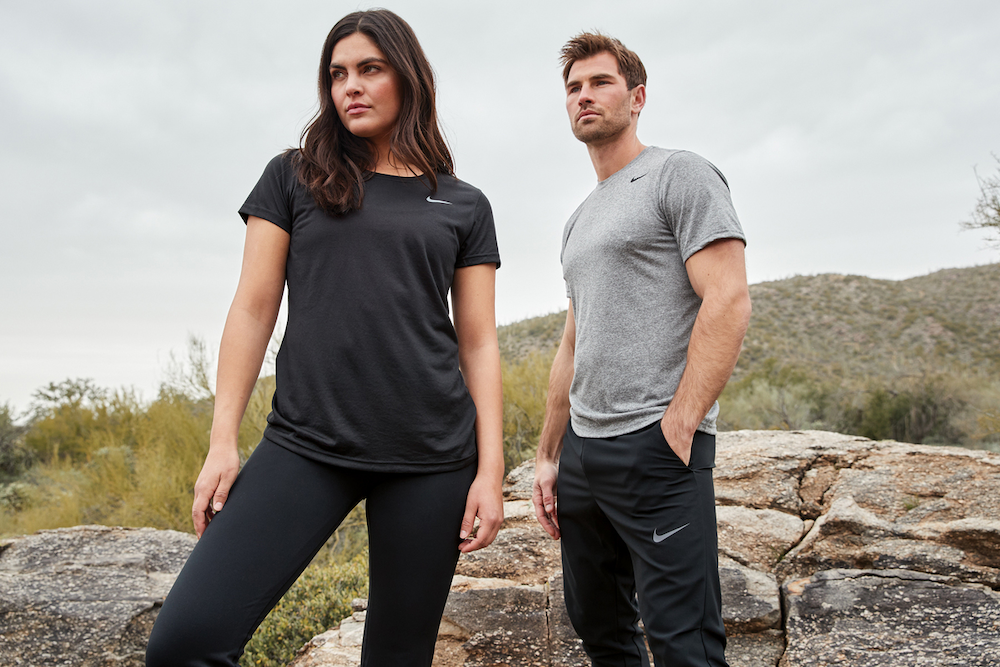 Man and woman wearing Nike t-shirts and pants can be custom branded by Swagger.