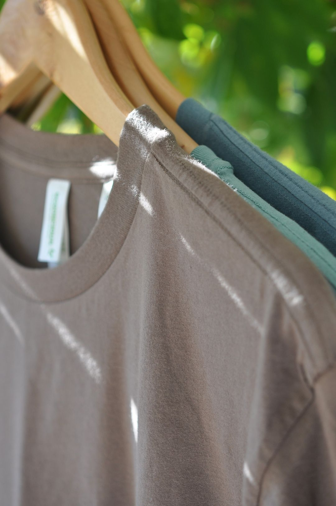 Three Econscious Unisex 100% Organic Cotton Short Sleeve T-Shirt on hangers curated by Swagger.