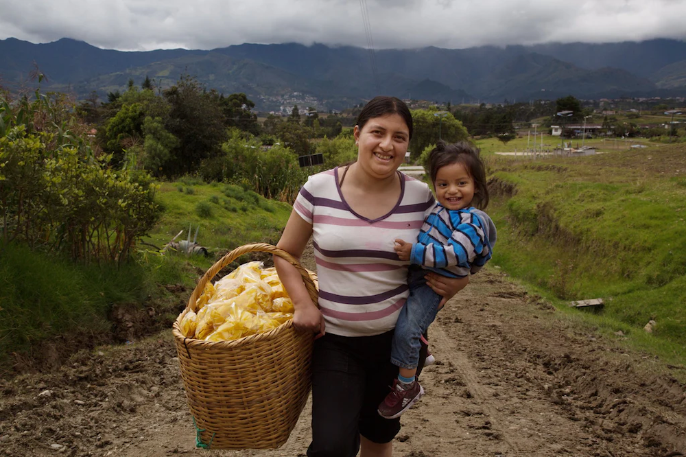 Woman and her child are a part of the CARE Ecuador program by Cotopaxi.