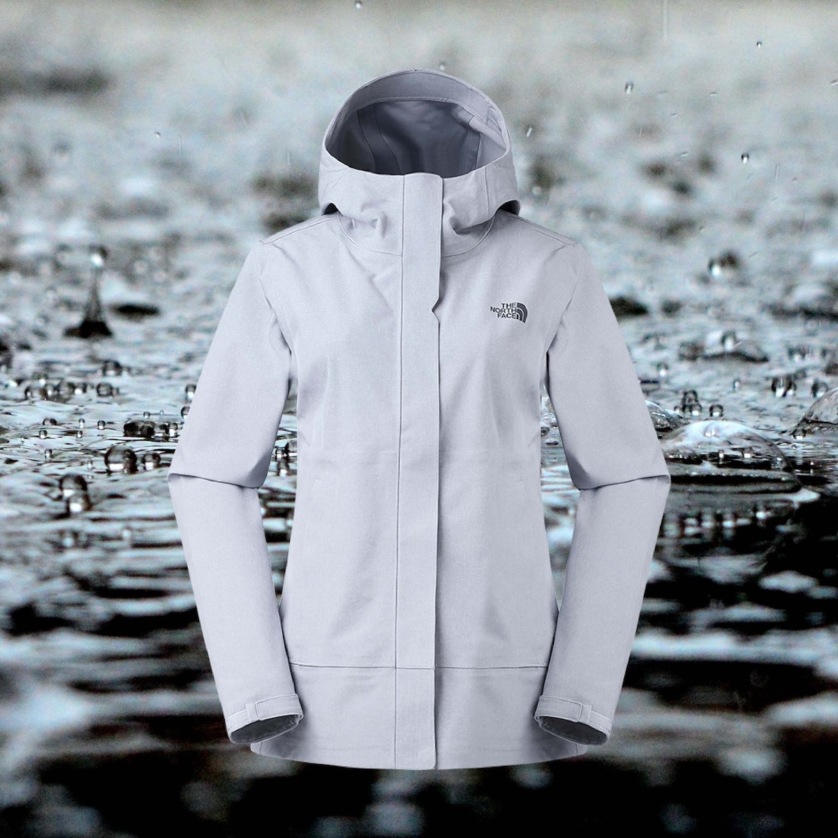North Face Women’s Apex Flex Dryvent Jacket in light gray against a background of raindrops.