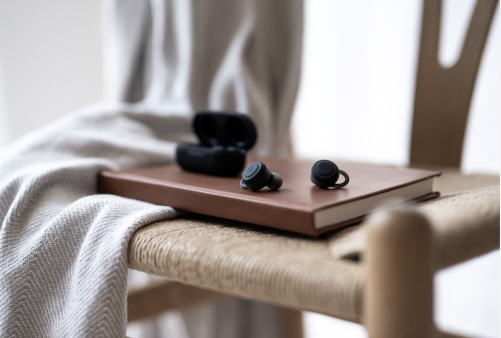 Urbanista’s Atlanta earphones sitting on a journal, curated by Swagger.